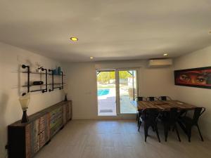 a dining room with a wooden table and chairs at Las Colinas in Illana