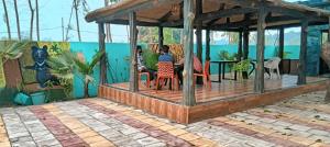 a rendering of a deck with people sitting at tables at Anha Farmstay in Mādho Tānda
