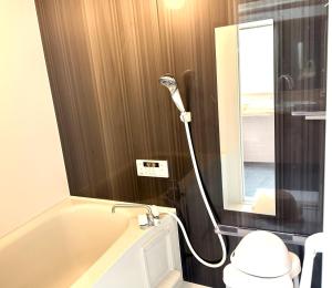 a bathroom with a shower and a toilet and a mirror at かみくまハウス in Kumamoto +16 photos