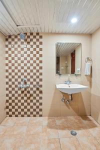 a bathroom with a sink and a mirror at Hotel Natraj International in Patnitop