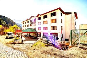 a building is under construction next to a street at Hotel Natraj International in Patnitop