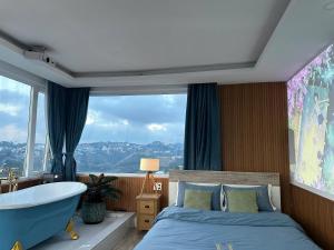 a bedroom with a bed and a tub and a window at Homey Home Đà Lạt in Da Lat