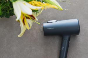 a hair dryer sitting next to a flower at SLL Urban Suites Akasaka in Tokyo