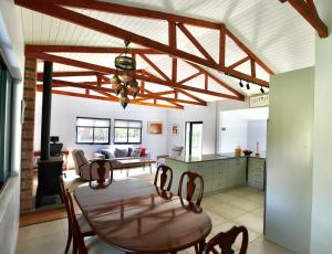 a kitchen and dining room with a table and chairs at sunbird cottage in Sedgefield +18 photos