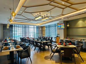 a dining room filled with tables and chairs at Park Inn by Radisson Lucknow Vikas Nagar in Lucknow