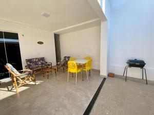a room with chairs and a table and a piano at Casa Alvorada in Flecheiras +11 photos