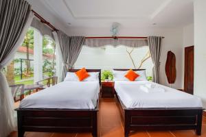 Una cama o camas en una habitación de Emma Bungalow