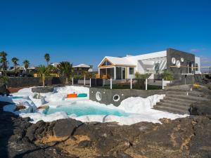 a house with a swimming pool in the snow at Luxury Family Villa with Private Pool, Jacuzzi & Sauna in Tahiche