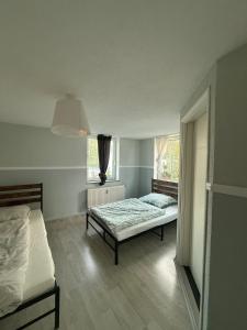 a bedroom with two beds and a window at möblierte Ferienwohnung in Günzburg in Ichenhausen