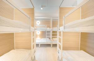 a room with three bunk beds in it at The Ostel Hostel Bangkok in Bangkok +44 photos