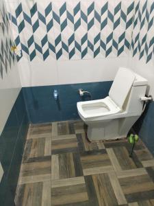 a bathroom with a toilet and a sink at Anha Farmstay in Mādho Tānda