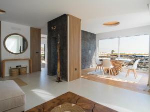 a living room with a table and chairs and a mirror at Luxury Family Villa with Private Pool, Jacuzzi & Sauna in Tahiche