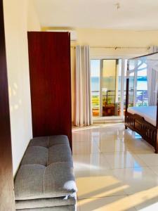 a bedroom with a bed and a view of the ocean at Oysterbay Palm Terrace serviced apt-nyali in Mombasa