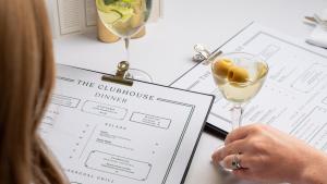 a woman sitting at a table with a glass of wine at Rockliffe in Darlington