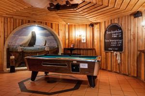 a pool table in a room with a sign at Hotel Iselmar in Lemmer