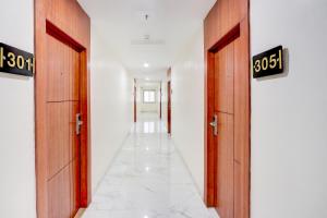 a hallway with two doors with the numbers on them at FabHotel Radha Rani Residency in Khammam +27 photos