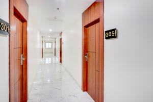 a hallway with two doors with numbers on them at FabHotel Radha Rani Residency in Khammam