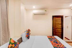 a white bedroom with a bed and a heater at FabHotel Radha Rani Residency in Khammam