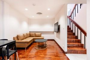 a living room with a couch and a table at Teja Hotel in Bangkok