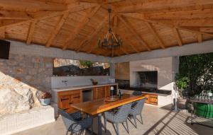 a kitchen with a table and chairs on a patio at Villa Pave-Makarska by Villas Guide in Juričići