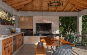 a kitchen with a wooden table and a dining room at Villa Pave-Makarska by Villas Guide in Juričići