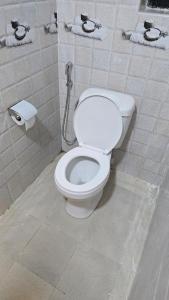 a bathroom with a white toilet in a room at Stylish Studio Retreat- Inside Kunste Hotel in Nakuru