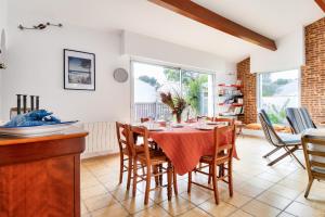 a kitchen and dining room with a table and chairs at 700m de la plage, jardin, 4 adultes 2 enfants in Le Fier