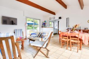 a living room with a table and chairs at 700m de la plage, jardin, 4 adultes 2 enfants in Le Fier