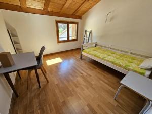 a room with a bed and a table and a desk at Maison 5 chambres à Dieulefit in Dieulefit