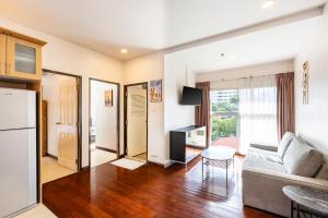 a living room with a couch and a table at Teja Hotel in Bangkok