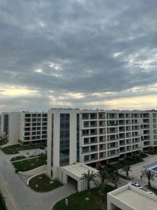 an aerial view of a large white apartment building at sea breeze park residences in Mekhrably