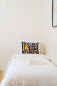 a white bed with a pillow on top of it at Haga Studio, Super Location with Full Comfort in Gothenburg