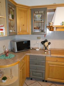 a kitchen with a counter top with a microwave at Da Matte e Ale - Tolmezzo in Tolmezzo +27 photos
