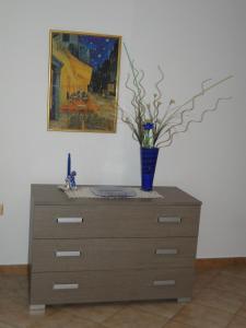 a dresser with a blue vase on top of it at Da Matte e Ale - Tolmezzo in Tolmezzo