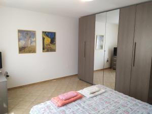 a bedroom with a bed and a mirror at Da Matte e Ale - Tolmezzo in Tolmezzo