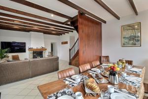a dining room with a table and a fireplace at La maison de la plage à 6 in Trégastel