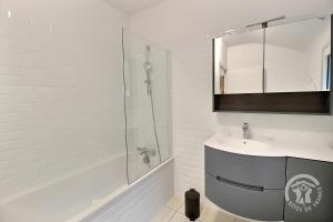 a white bathroom with a sink and a shower at La maison de la plage à 6 in Trégastel +21 photos