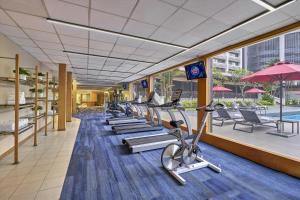 a gym with rows of exercise bikes and a pool at Concorde Hotel Kuala Lumpur in Kuala Lumpur
