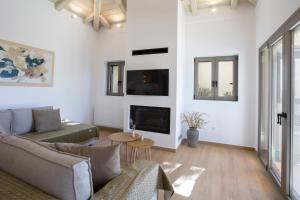 a living room with a couch and a fireplace at VV Luxury Villas in Lefkada Town