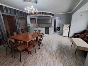 a dining room and kitchen with a table and chairs at Hostel Dilijan in Dilijan +32 photos