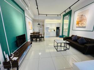 a living room with a couch and a table at Chamber Suites KL At Sky World in Kuala Lumpur