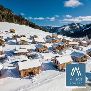 a ski resort in the mountains covered in snow at Almdorf Hohentauern by ALPS RESORTS in Hohentauern