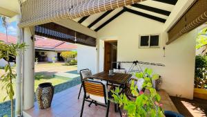 a patio with a table and chairs on a house at Villa Caballero in Au Cap