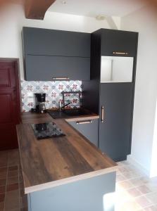a kitchen with a wooden counter top in a room at Au Cœur De Guérande - Intra Muros in Guérande