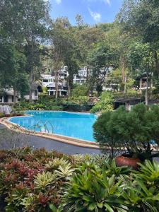 a swimming pool in a yard with trees and bushes at K5 Seaview Hillside 3BR and 1 Staff Quarter in Ban Ko Kok