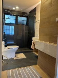 a bathroom with a shower and a toilet and a sink at K5 Seaview Hillside 3BR and 1 Staff Quarter in Ban Ko Kok +22 photos
