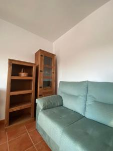 a living room with a couch and a book shelf at Las Palomas in Benamahoma