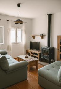 a living room with a couch and a stove at Las Palomas in Benamahoma +53 photos