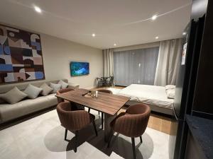 a living room with a table and a couch at sea breeze park residences in Mekhrably