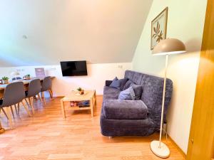 a living room with a couch and a table at Apartment BergWiese 225 in Donnersbachwald